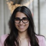 Headshot of Pari Paruthi in a bricked hallway.