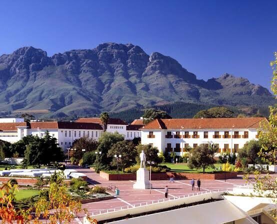 Stellenbosch University (wide view): Stellenbosch University nestled at the foot of the Stellenbosch Mountains in South Africa.