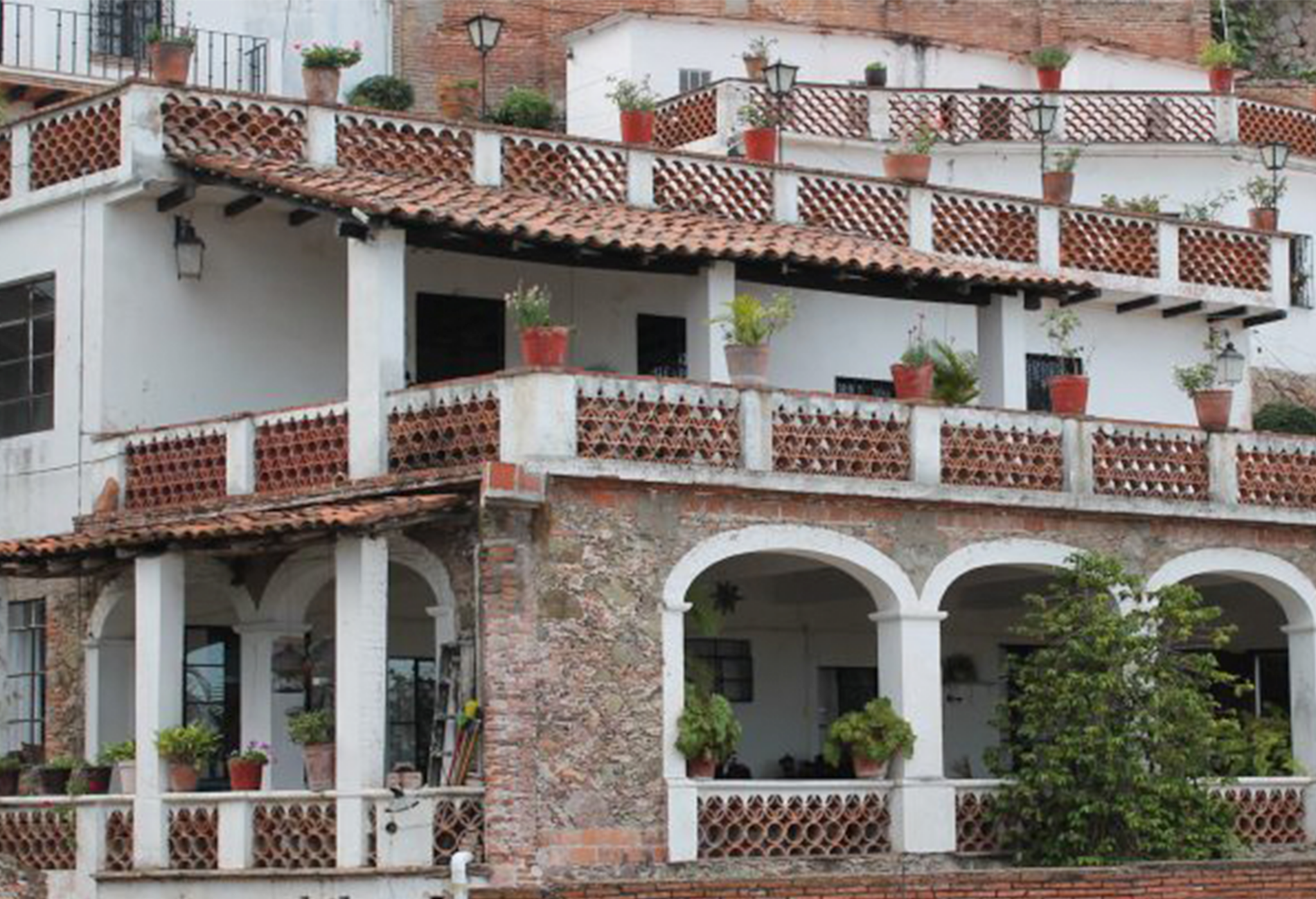 A red and white building in Mexico displaying the beautiful architecture in the city.